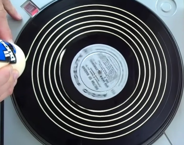 applying wood glue on the record