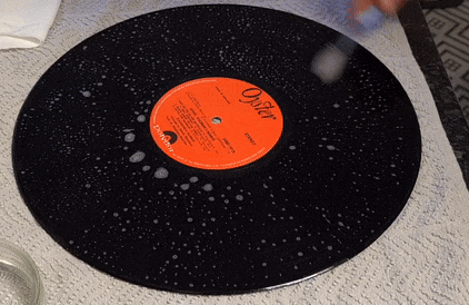 deep cleaning vinyl record using tooth brush