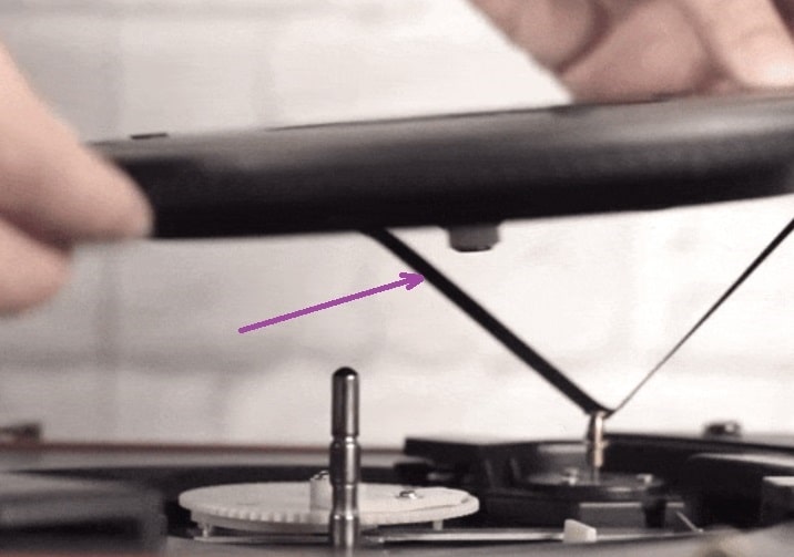 an image showing motor belt underneath platter of record player