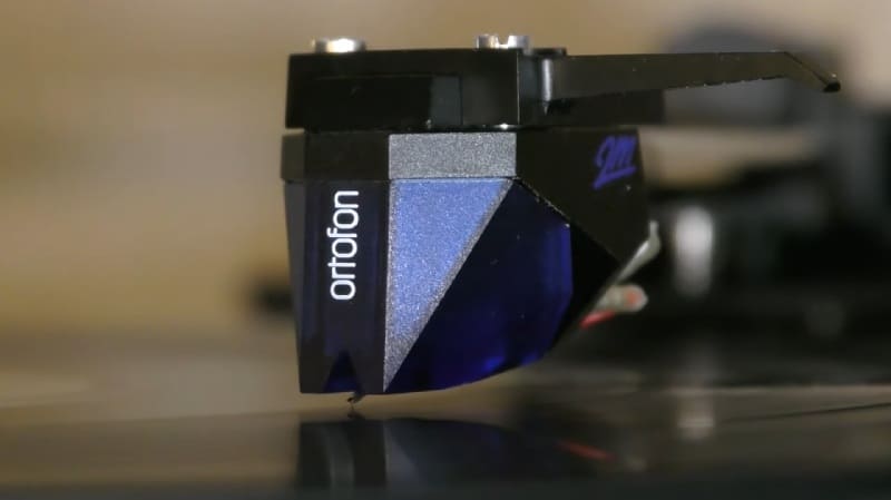 an image showing Ortofon 2M Blue MM Cartridge running on record groove