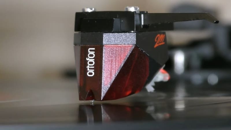 an image showing Ortofon 2M Red MM Cartridge running on record groove