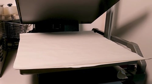 an image showing how to place record inside parchment paper before putting inside heating press